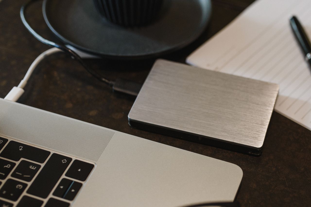 External hard drive plugged into a laptop during an office data backup