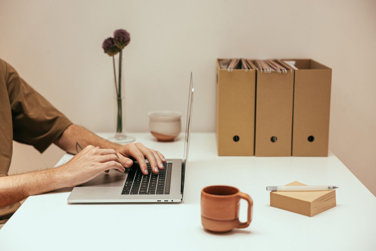 A person sending large files from a laptop in an office